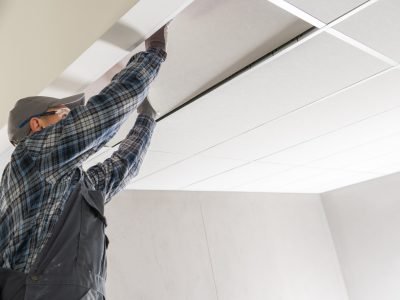 Construction Site Worker Installing Suspended Ceiling Construction Site Worker Installing Suspended Ceiling Inside a Commercial Building